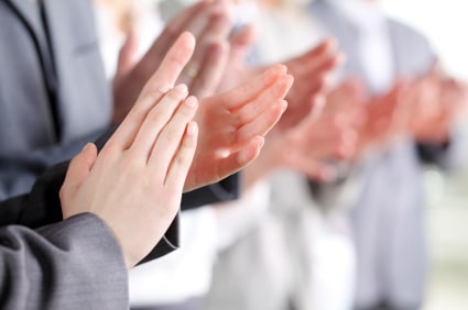 Photo of business partners hands applauding at meeting and standing in a row.