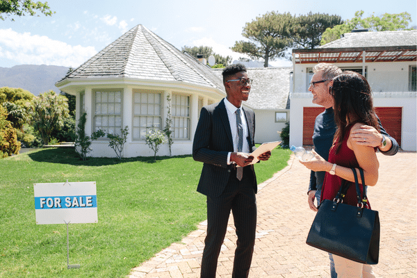 couple speaking with a real estate agent