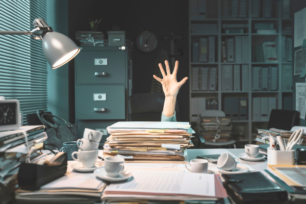 person drowning in paperwork